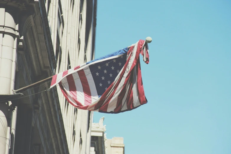 american flag being waved in the wind by an upward arrow