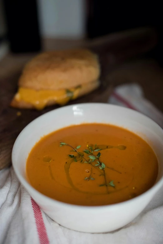 soup in a white bowl with parsley on the side