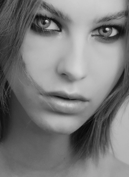 black and white portrait of a beautiful woman with large, pierced eyes
