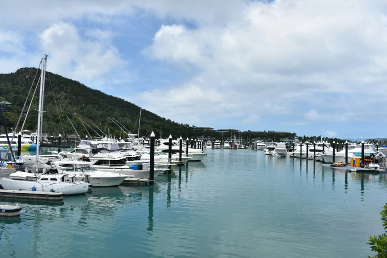 a harbor that has boats in it under a cloudy sky