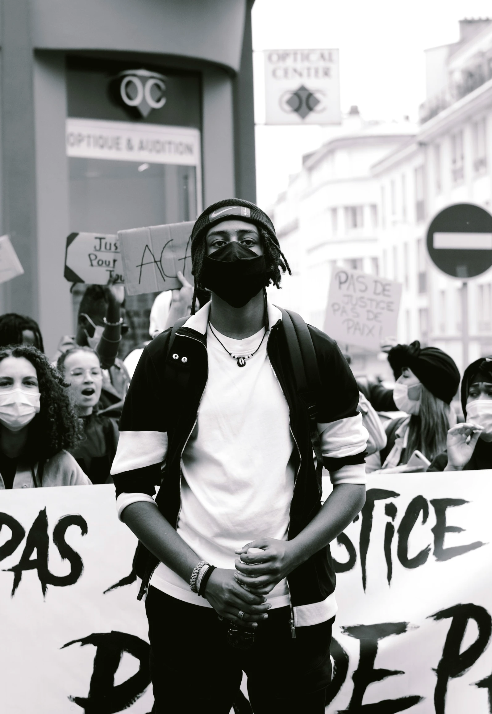 a man holding a sign and standing in the street