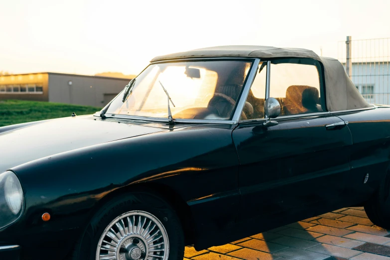 a man is driving an old convertible car