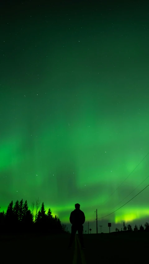 a green and blue sky with many aurora lights