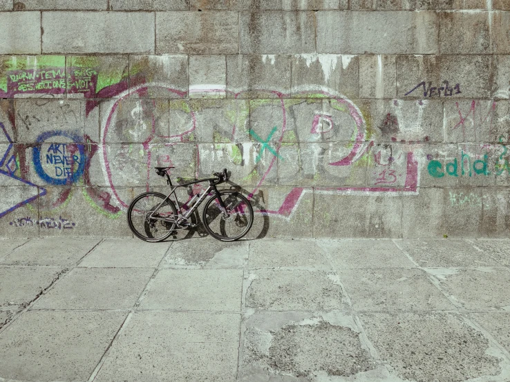 bike parked against wall covered in graffiti