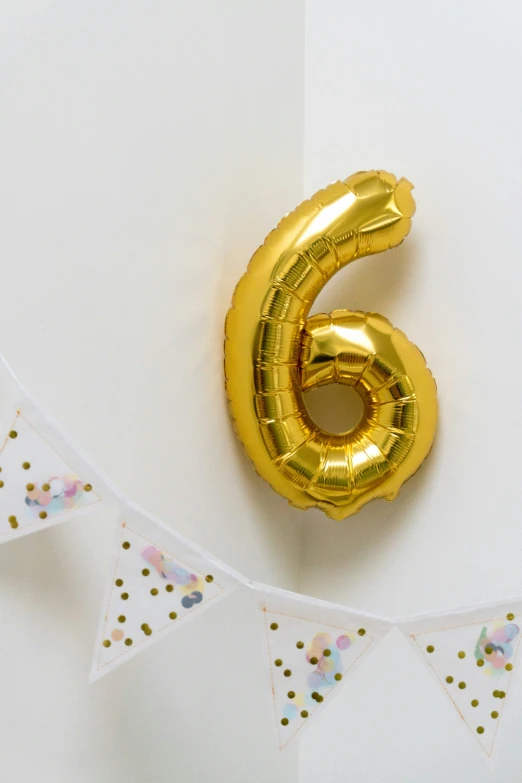 number 6 balloon sitting on top of a table