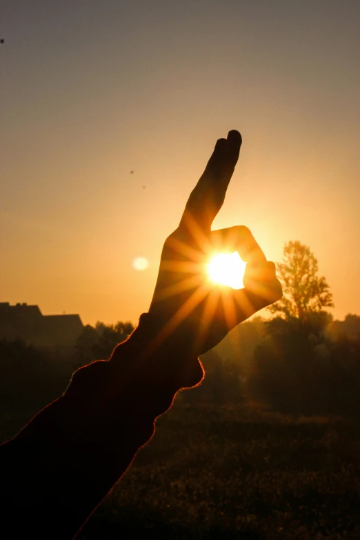 the sun is rising above the hills and it is the only visible one in this image