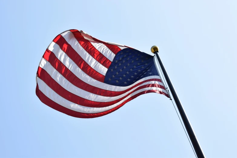 a flag waving in the wind on a flagpole