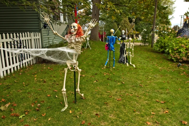 skeleton decoration stands in yard, with two children