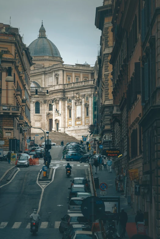 a city street with cars and a building behind it