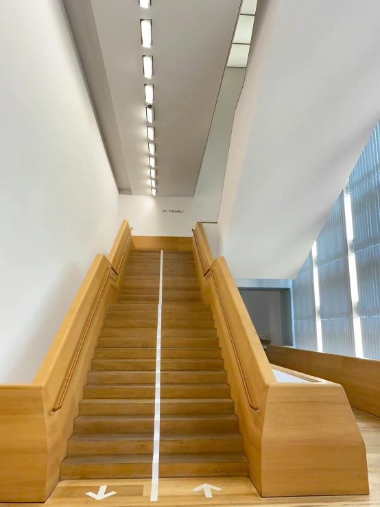 a wooden stairway with white painted strips going up