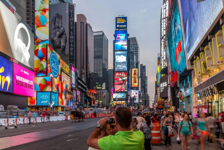 people walk through the crowded street in the city