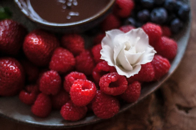 berries, raspberries, strawberries, and a cup of  chocolate
