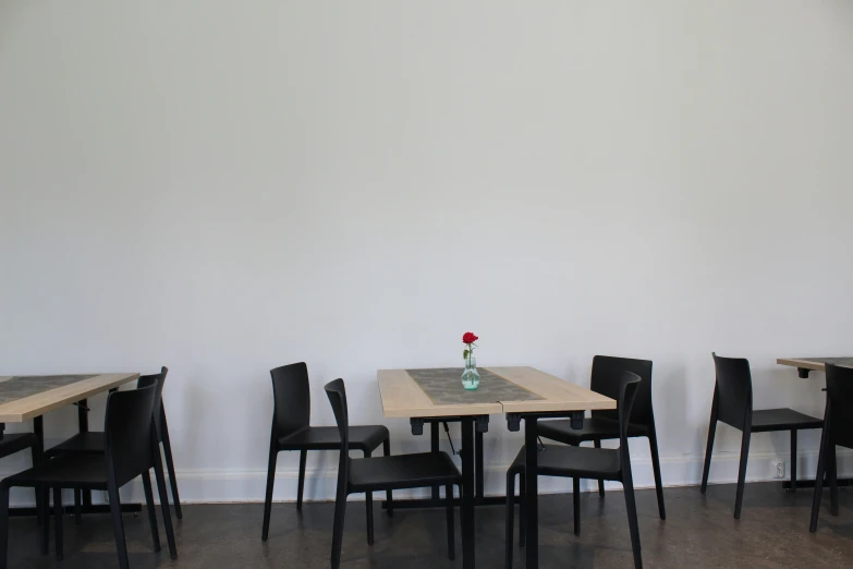 empty restaurant tables and chairs line the wall