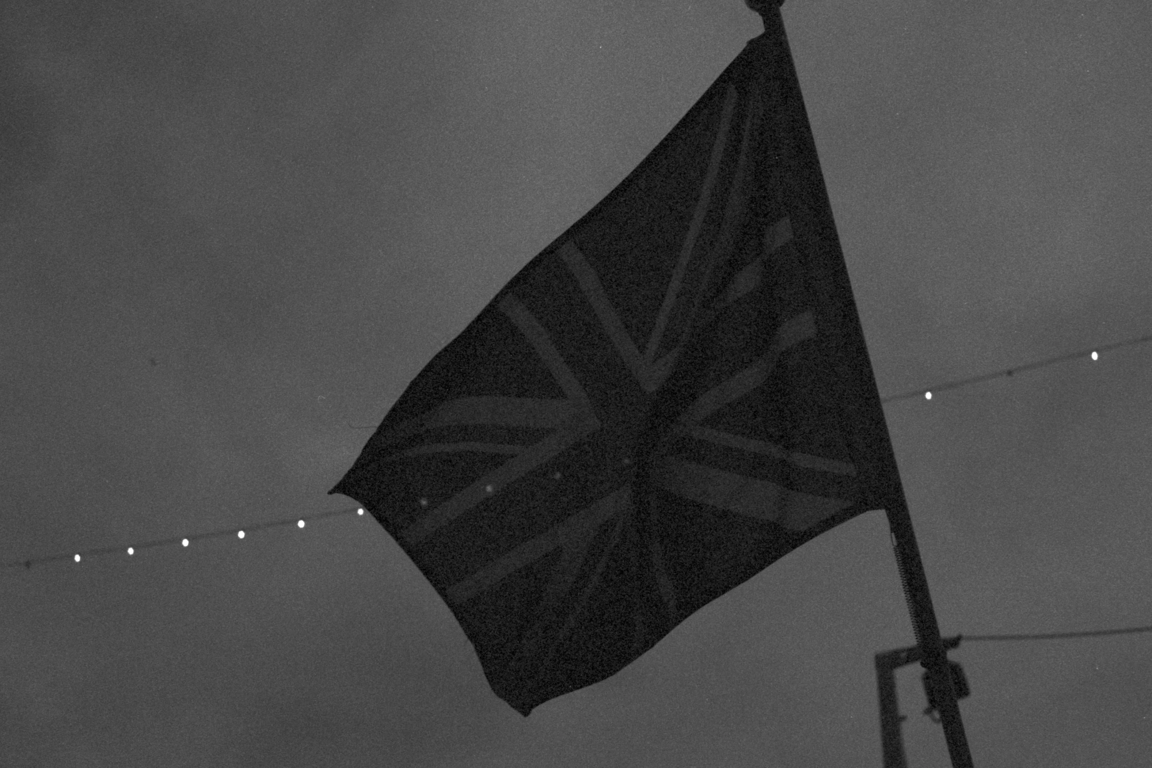 a british flag is flying on top of the roof of a building