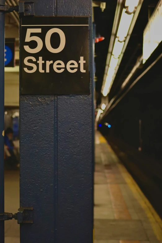 there is a street sign mounted on the side of a pole