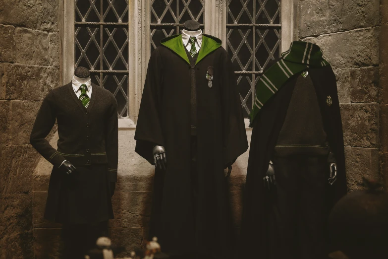 two black and green harry potters with green hoodies