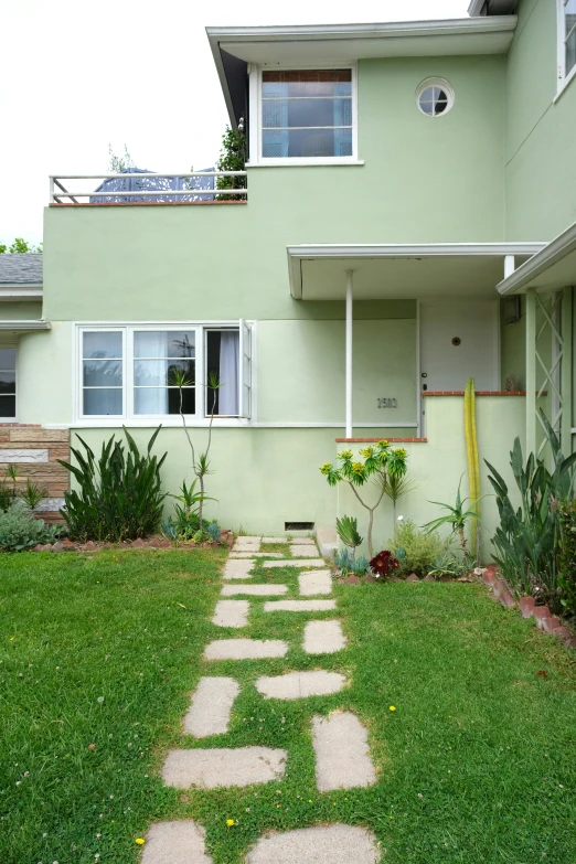 a house with a big lawn outside next to it