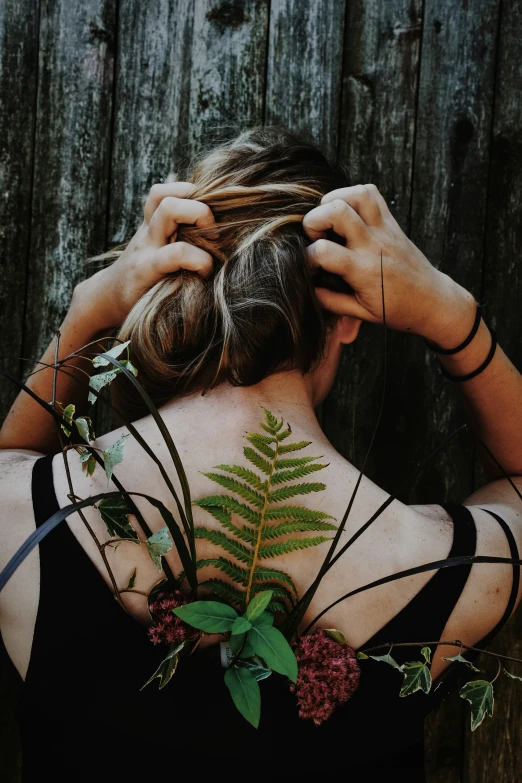 a person wearing a black shirt and some plants