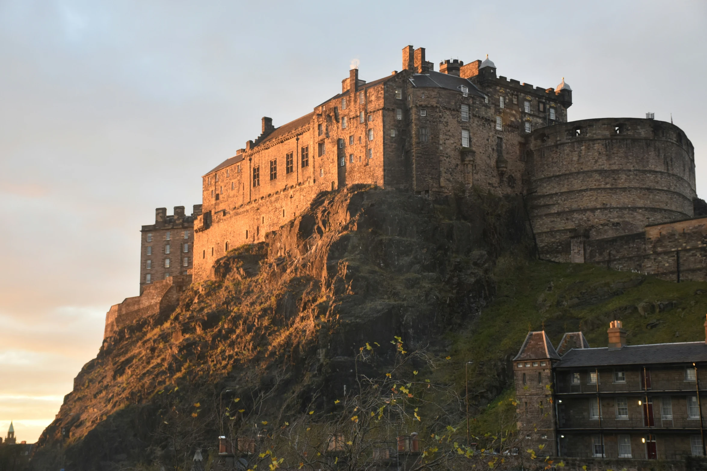 the castle sits on a large hill above buildings