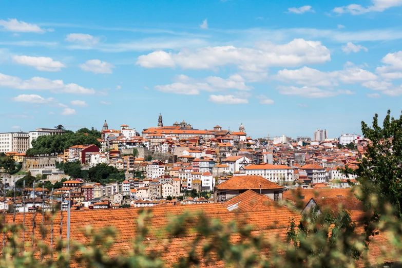 an elevated view of a city with rooftops and buildings