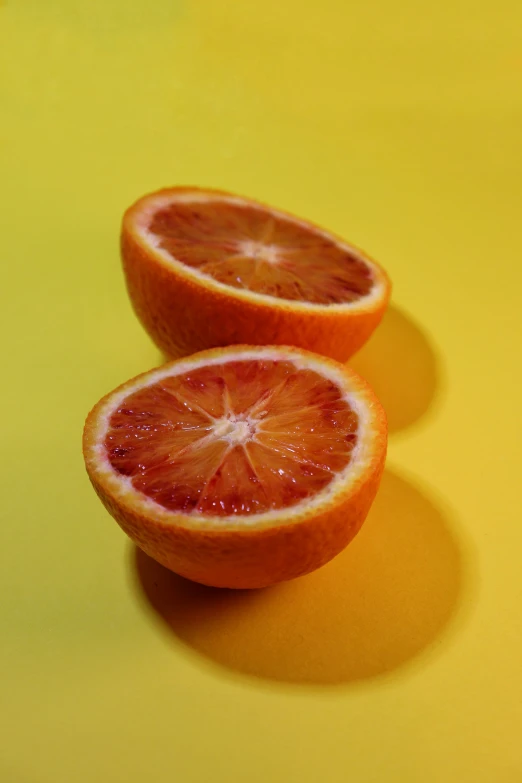 there is one orange sliced in half and a whole