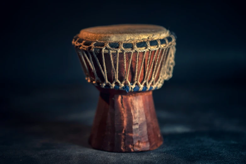 a wooden african music drum with black dots