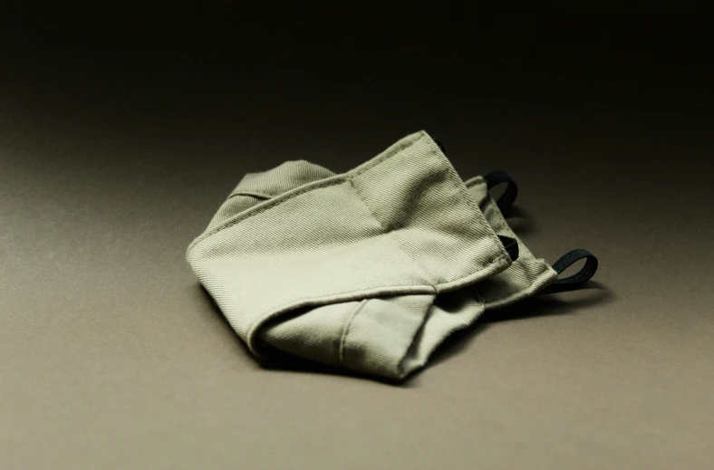an empty pouch for clothes on a dark surface