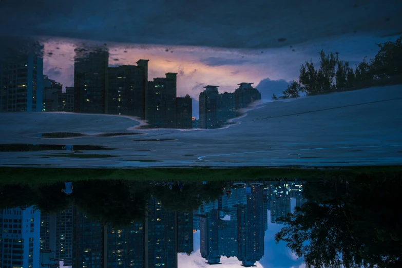 a cloudy evening and a pograph of some buildings that are all reflecting in the water