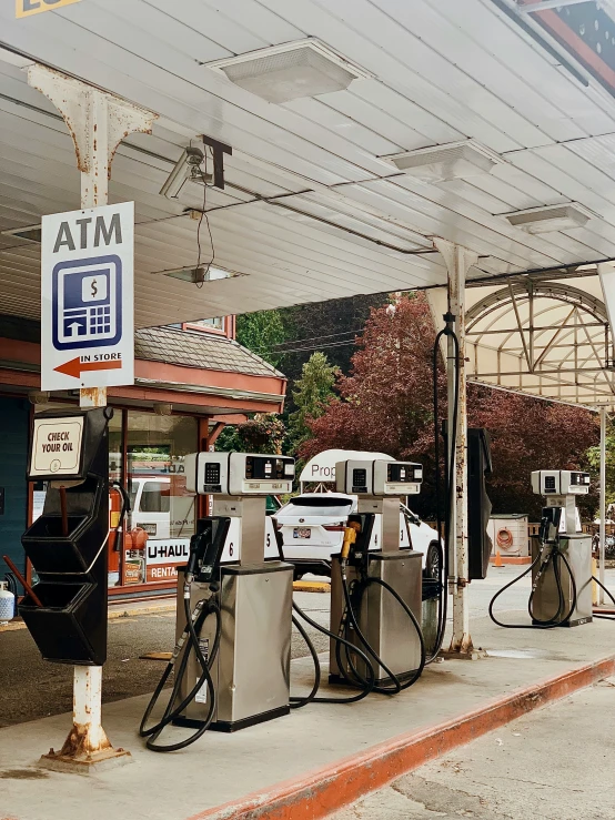 a row of gas pumps at an outside gas station