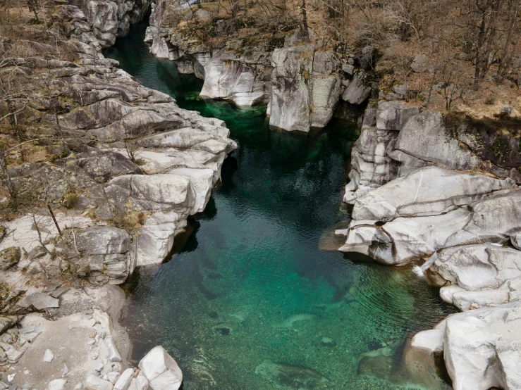 the deep pools of a canyon on an island are filled with green water