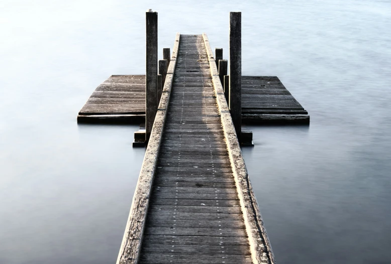 a very long pier sticking out of a lake