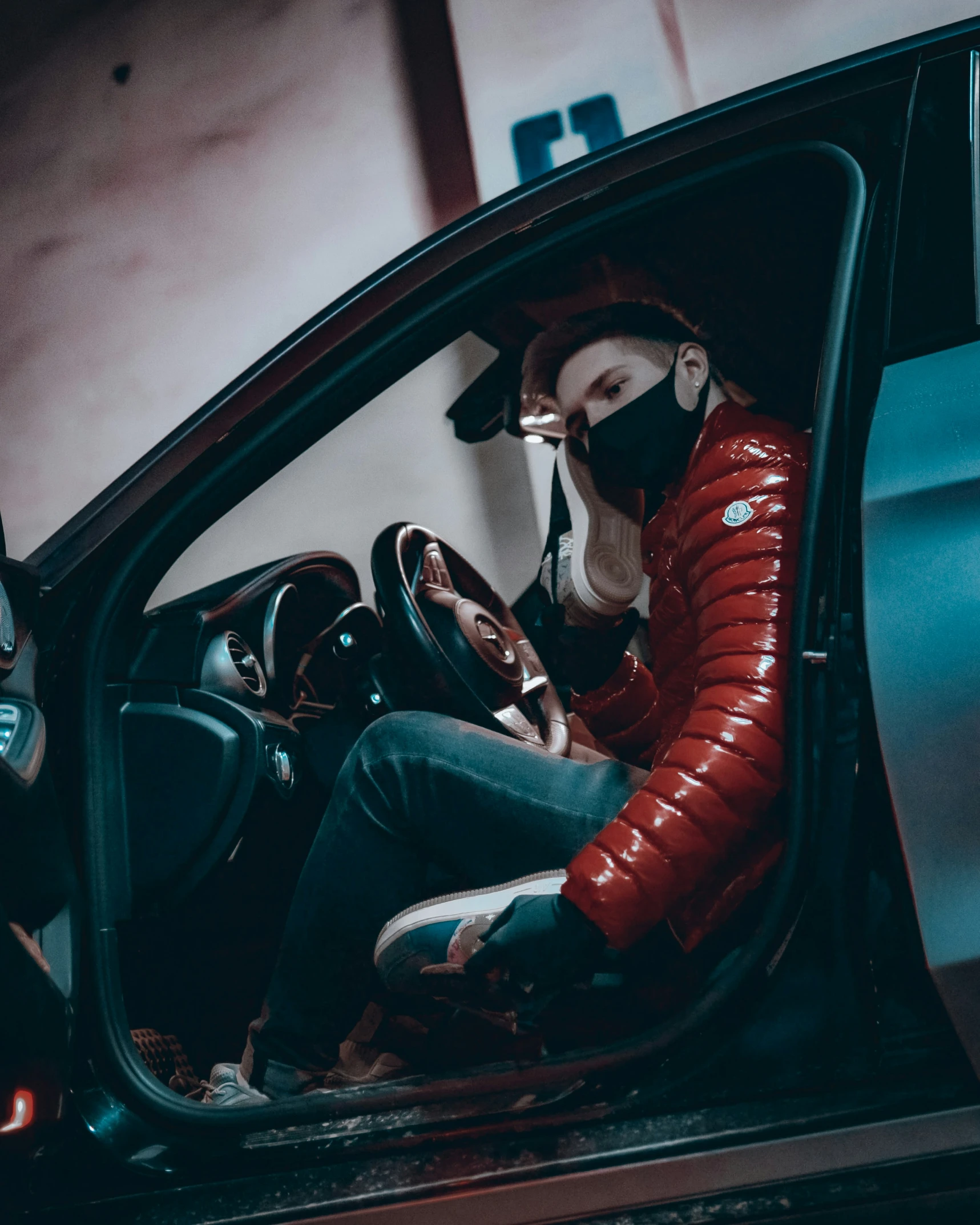 woman wearing a mask while driving a car