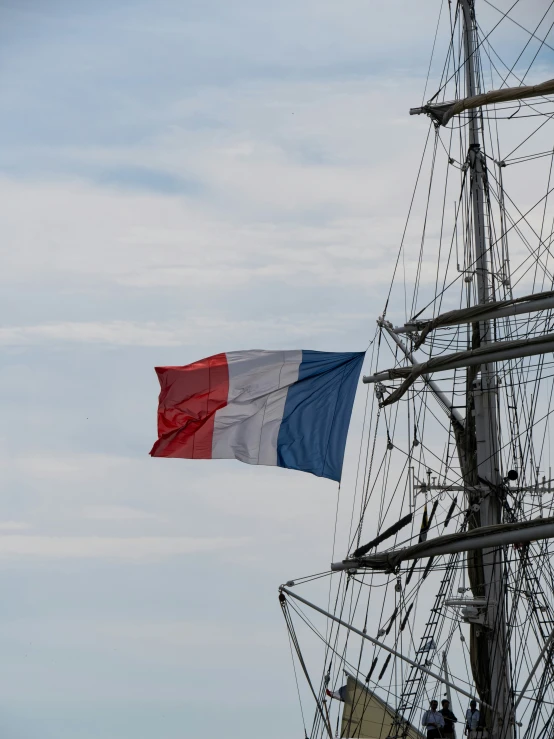 the red white and blue flag is flying on top of the boat