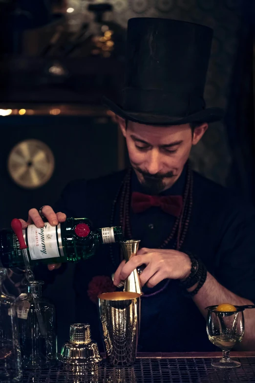 a bartender mixes a cocktail in his glass