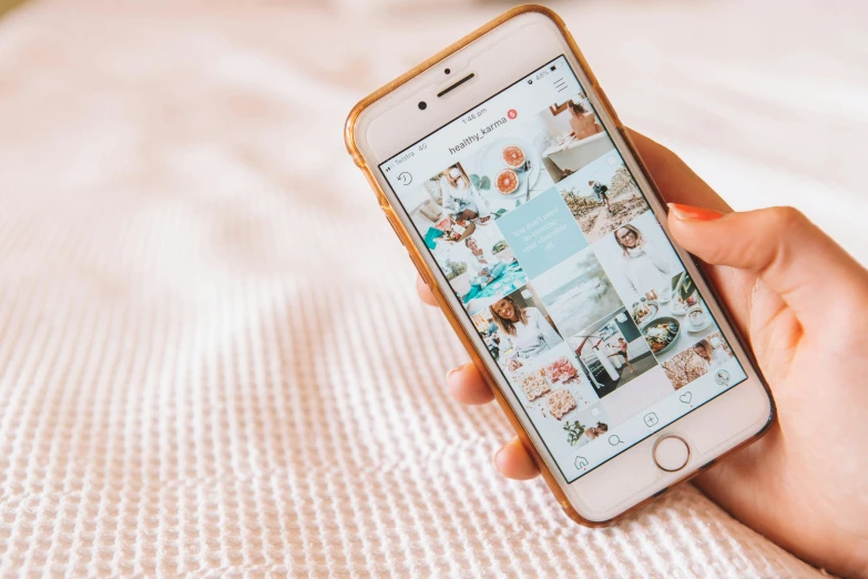 a woman looking at her cell phone on the bed