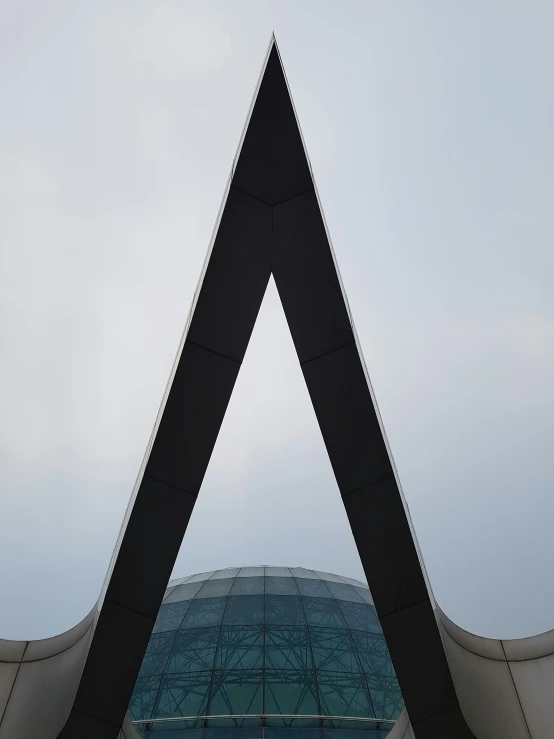 the triangular shape of an architectural building with a clock tower at the top