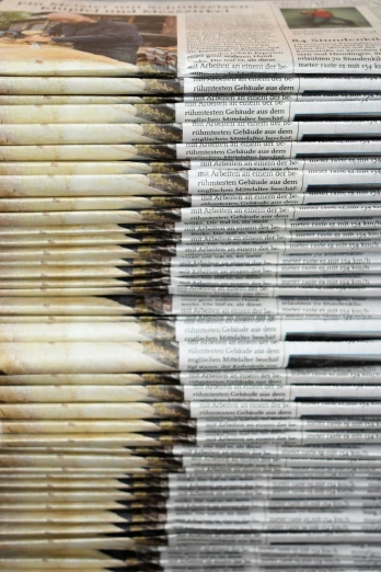 some newspaper stacked high together on top of each other