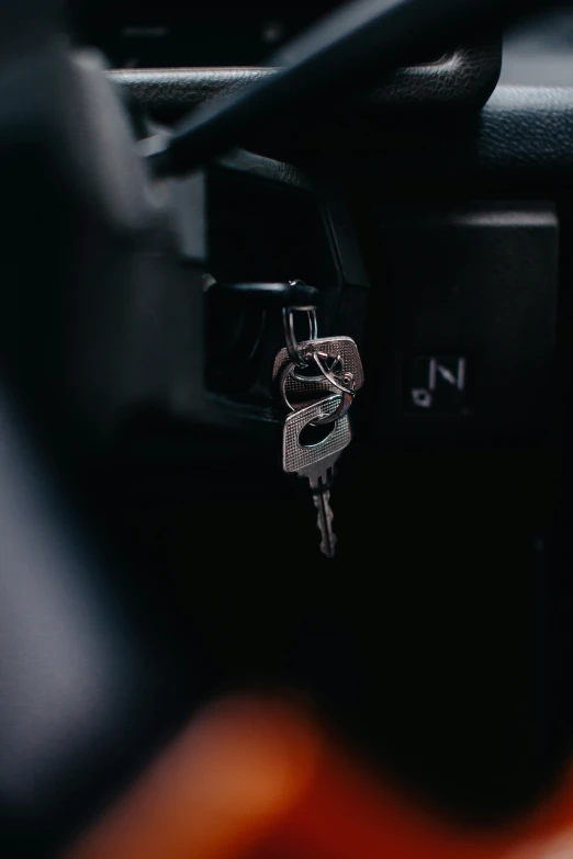 a car dashboard with keys hanging from the dash board