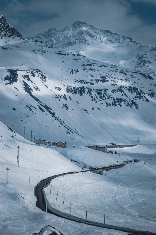 snow covered mountains and a road are near each other