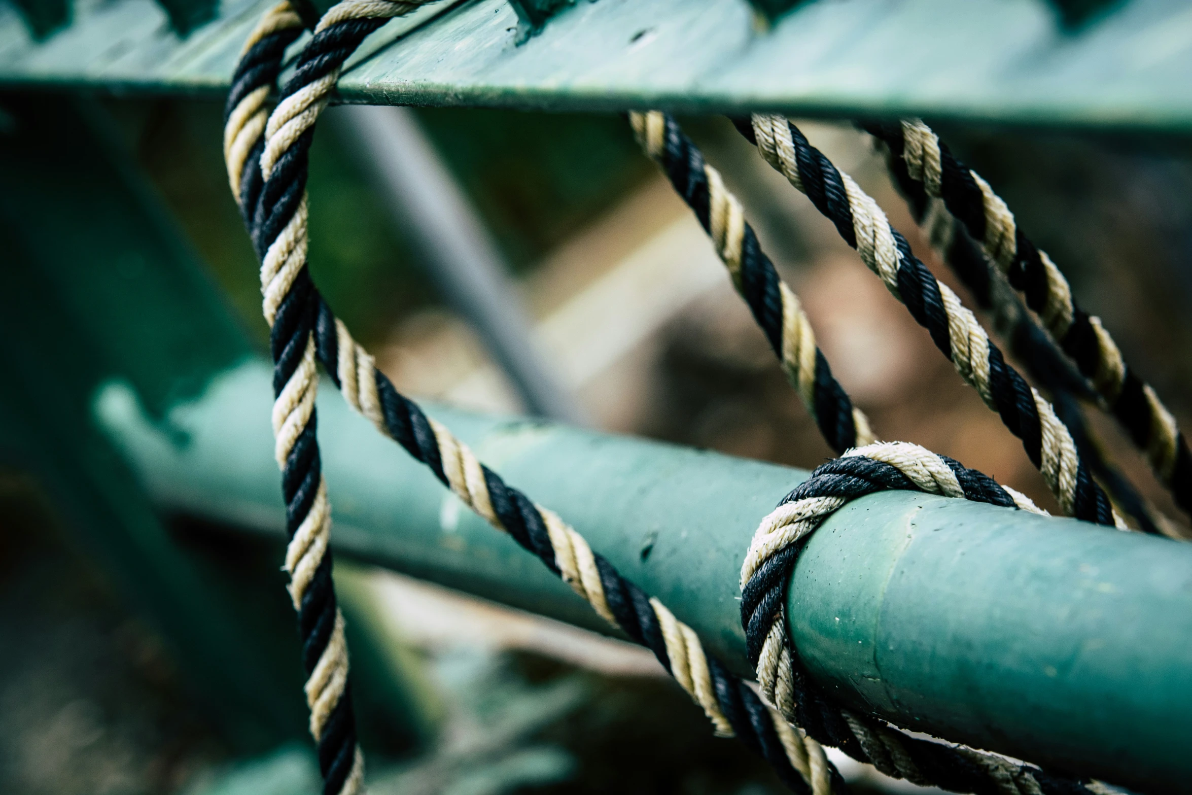 the rope is tied up to a metal structure