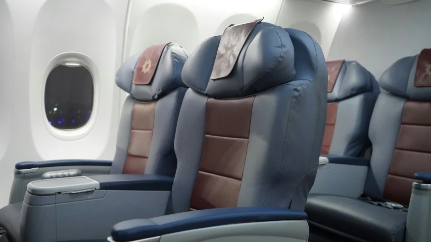 seats in an airplane with no windows, and a view of the wing area