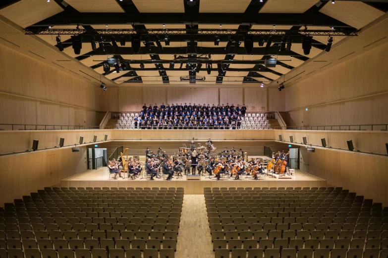 a large concert hall filled with people and musicians