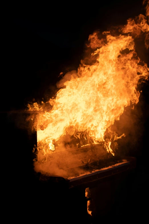 a large fire burning on top of a wooden table