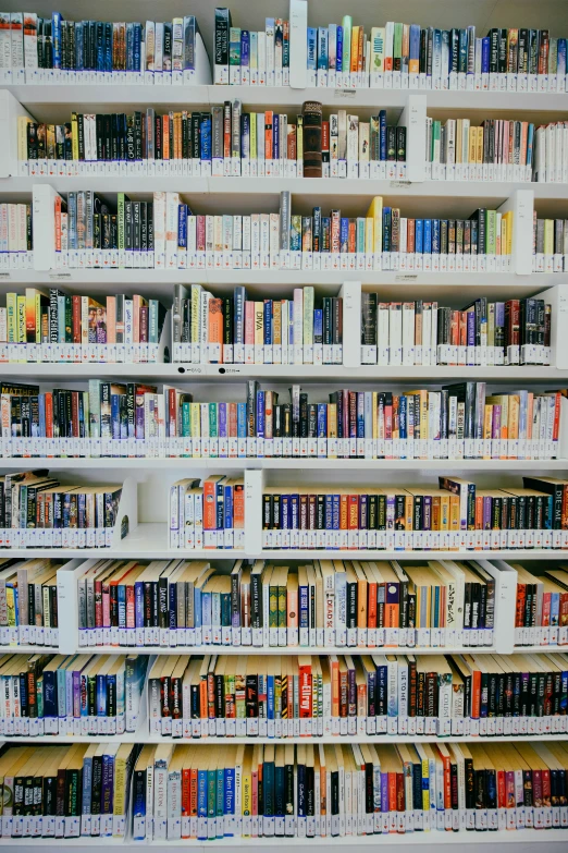 several shelves are stacked together with a variety of books