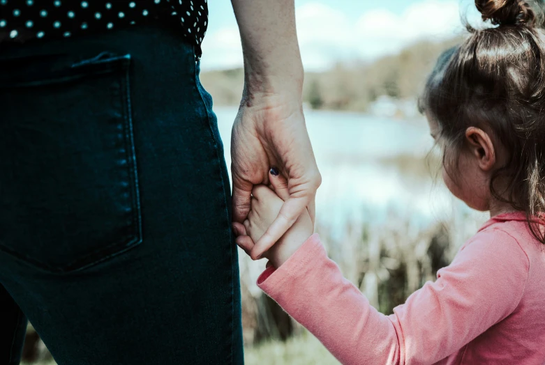 an older woman holding the hand of a 