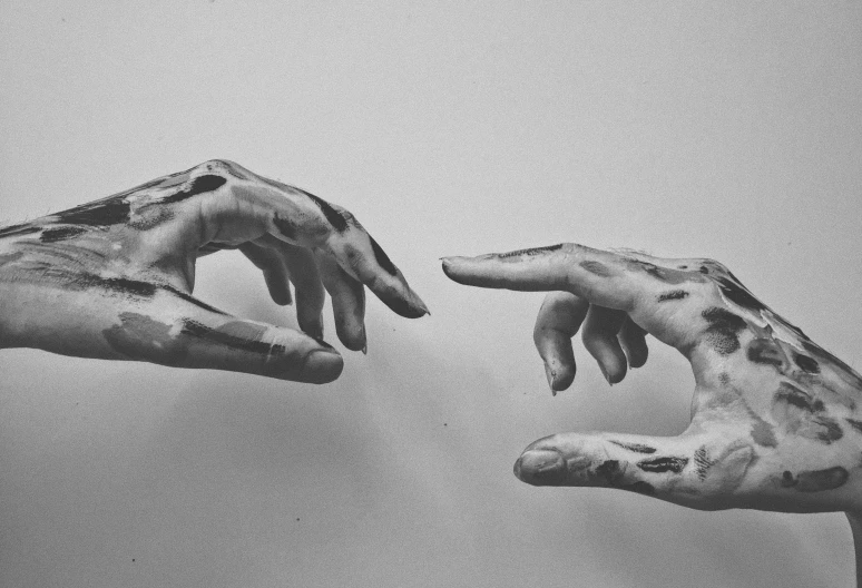 a picture of two hands reaching towards each other