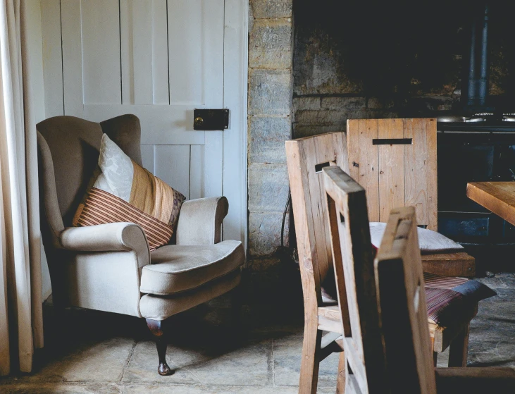 a couch, chairs, a table and fireplace in the corner of a room