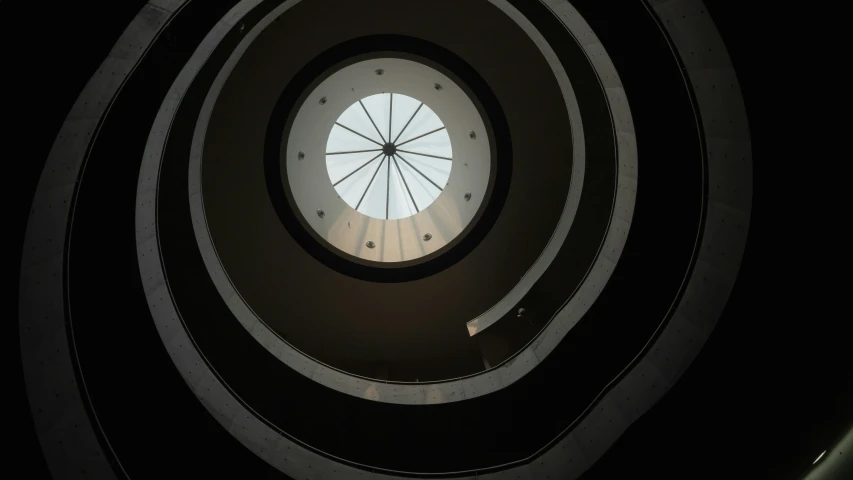 the light in the center of the ceiling shines on the skylight