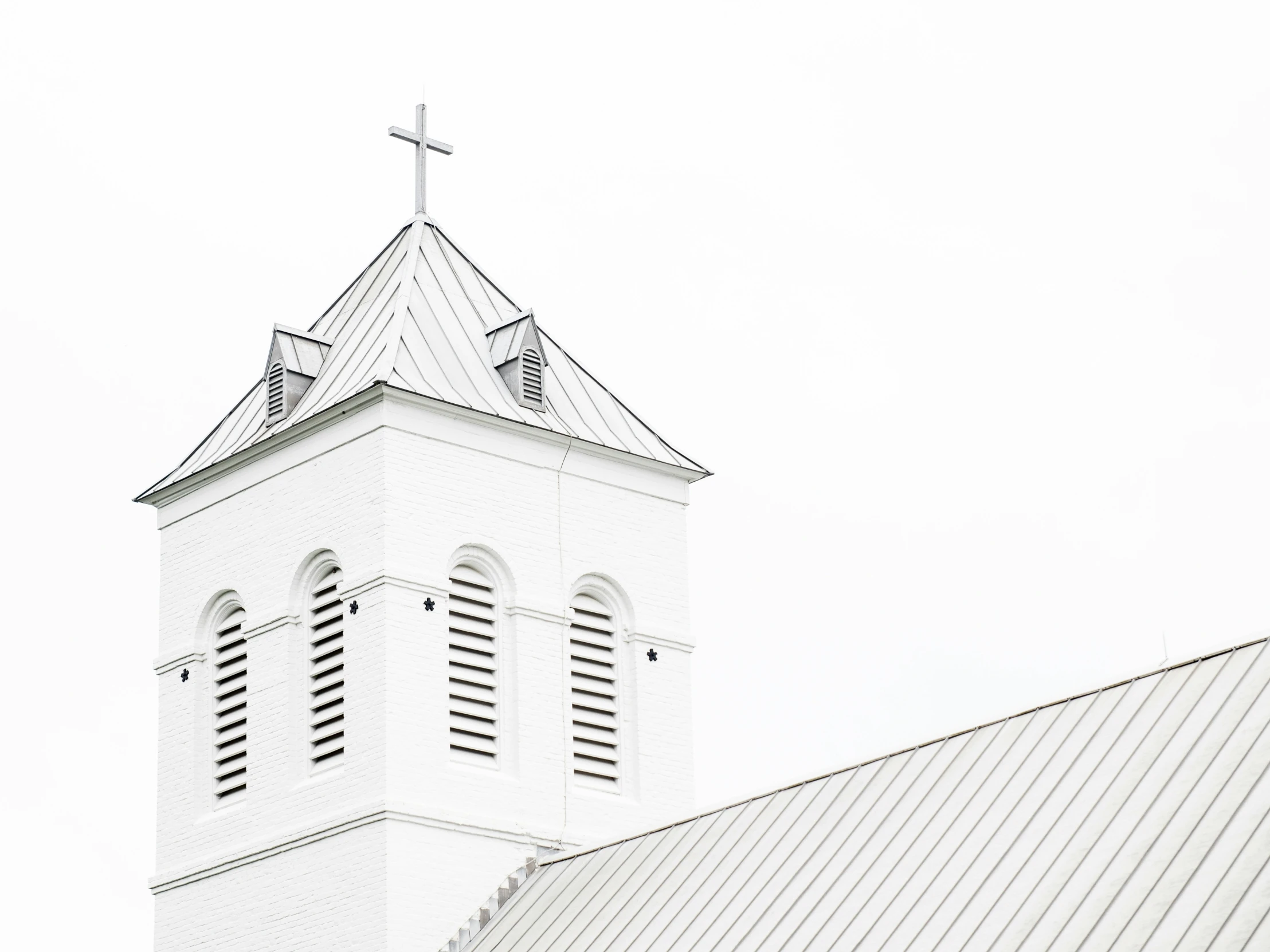 a church steeple with a metal roof