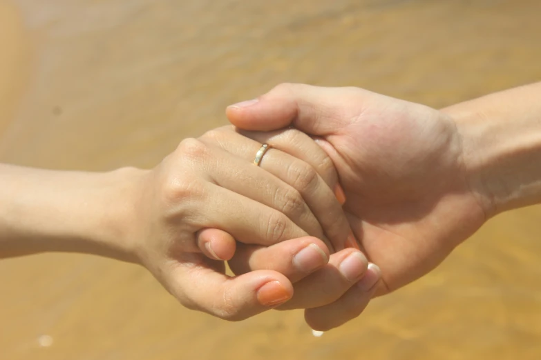 a man holding the hand of his female in his hand